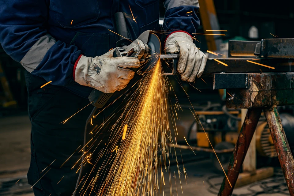 Deux ouvriers en équipements de protection individuelle travaillent sur une charpente métallique en construction